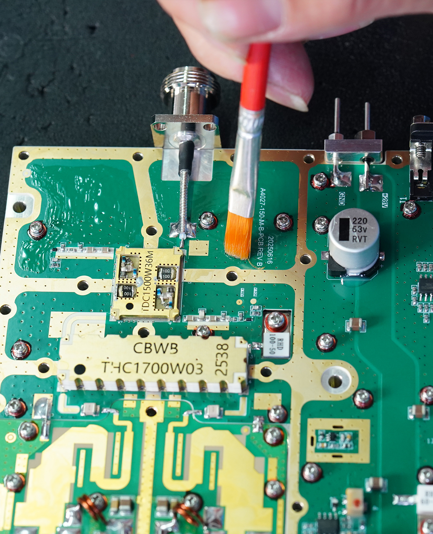 Finished conformal-coated RF PA module connected to a 28 V test system for RF output and VSWR verification