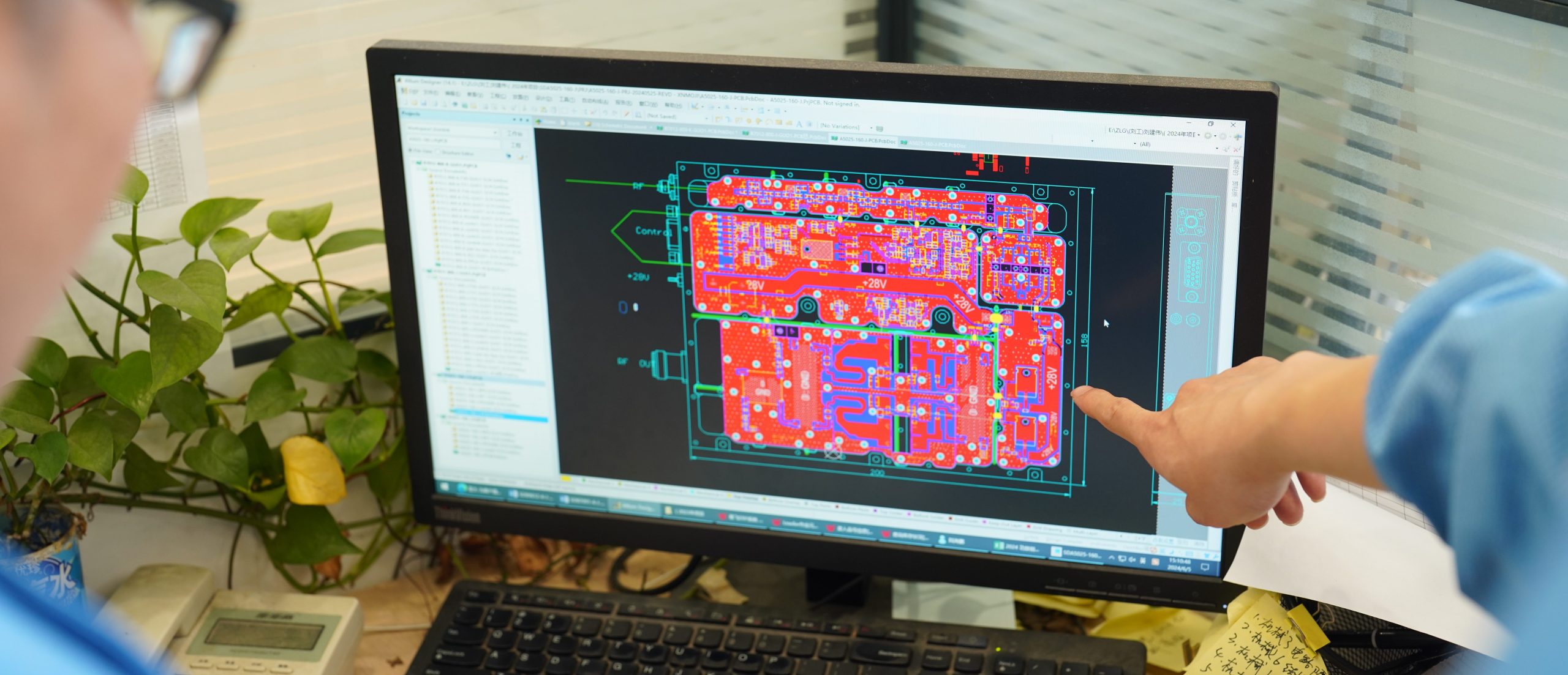 Engineer reviewing an RF power amplifier PCB layout during a hardware and configuration change assessment