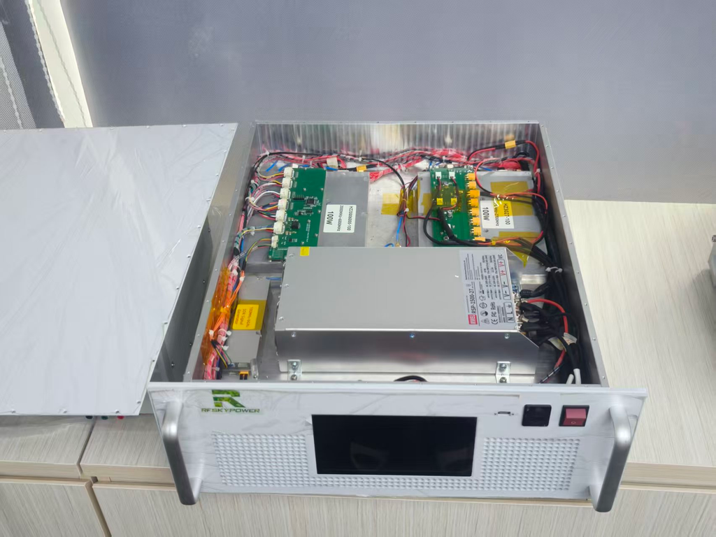 Open RF SKYPOWER cabinet showing internal RF amplifier modules, power supply, control boards, wiring, and the front panel for system layout review.